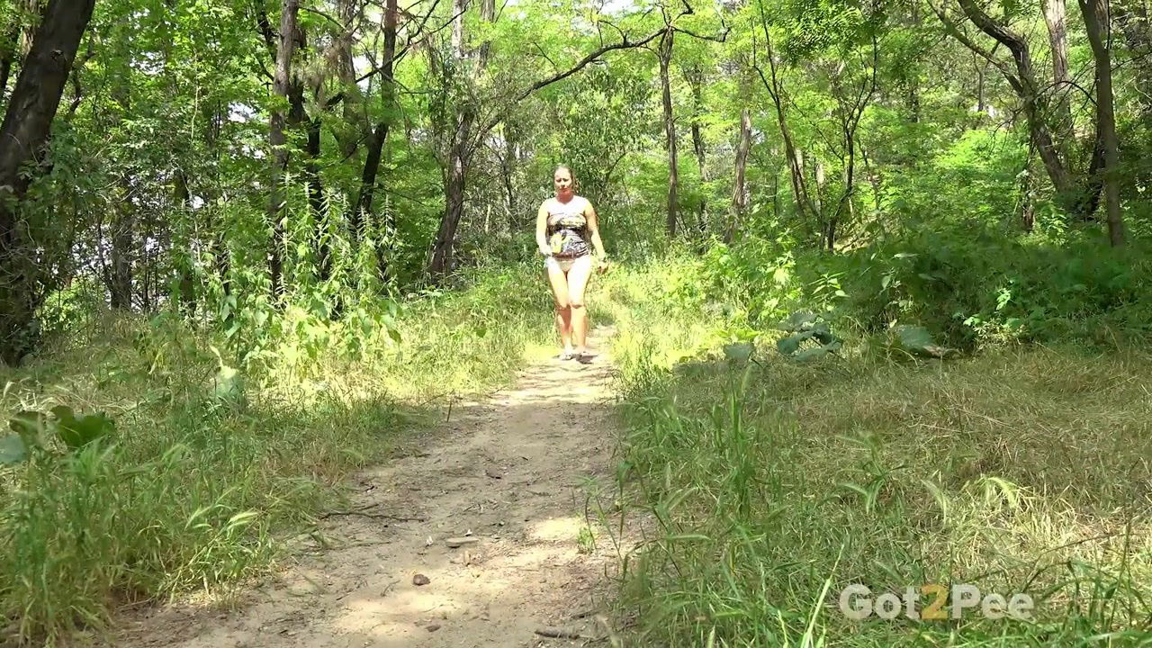 Blonde babe Licky Lex squats to pee in the woods